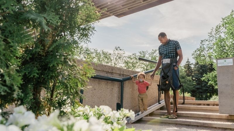 A father and son walking down the stairs.